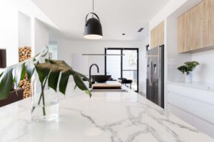 Kitchen marble bench close up with black hanging pendant