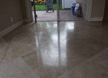 Worn polished travertine floor refinished to a honed finish and sealed