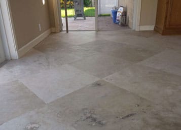 Worn polished travertine floor refinished to a honed finish and sealed