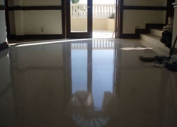 Dull limestone floor restored to a new polished and reflective finish