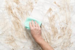 Cleaning marble surface with a piece of cloth